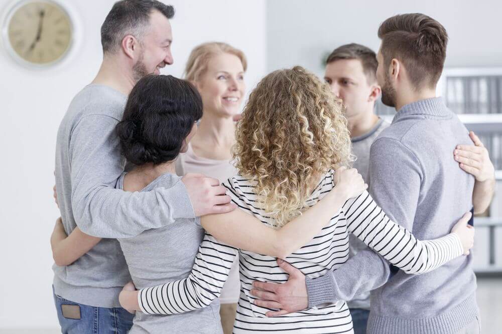 Bachelor's Psychology Students Hugging After a Practice Session
